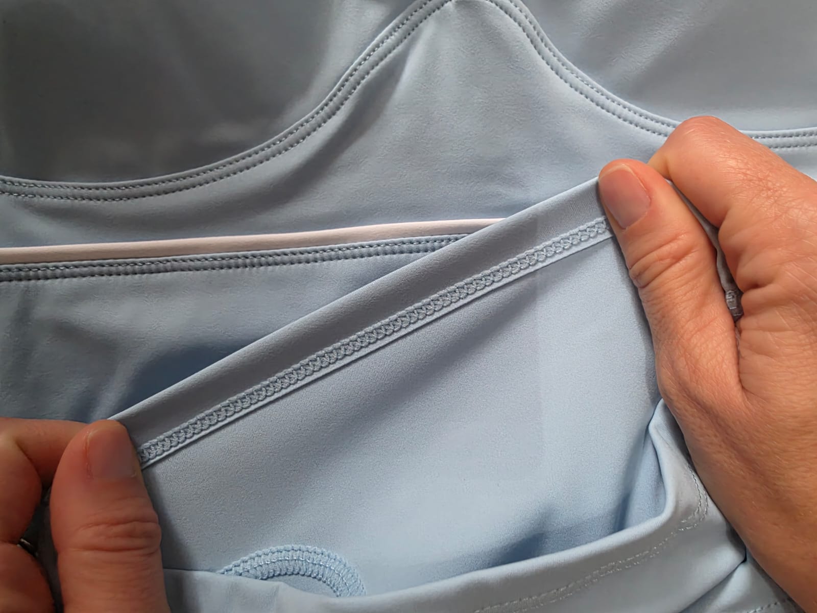 Close-up of blue yoga clothing showing the inside stitching and seam construction